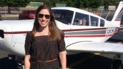 a woman standing in front of a plane