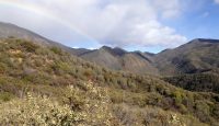 a rainbow over a mountain range