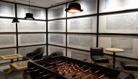 a room with a foosball table and chairs