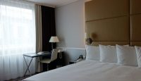 a bed with a desk and lamp in a hotel room