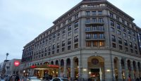 a building with many windows and cars on the street