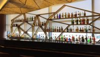 a bar with many bottles of alcohol