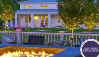 a fire pit in front of a white house