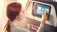 a woman using a tablet on an airplane