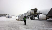 a man standing next to a plane