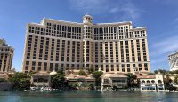 a large building with many windows with Bellagio in the background