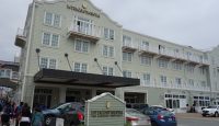 a building with a sign and cars parked in front of it