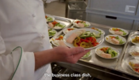 a chef holding a plate of food