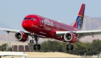 a red airplane taking off