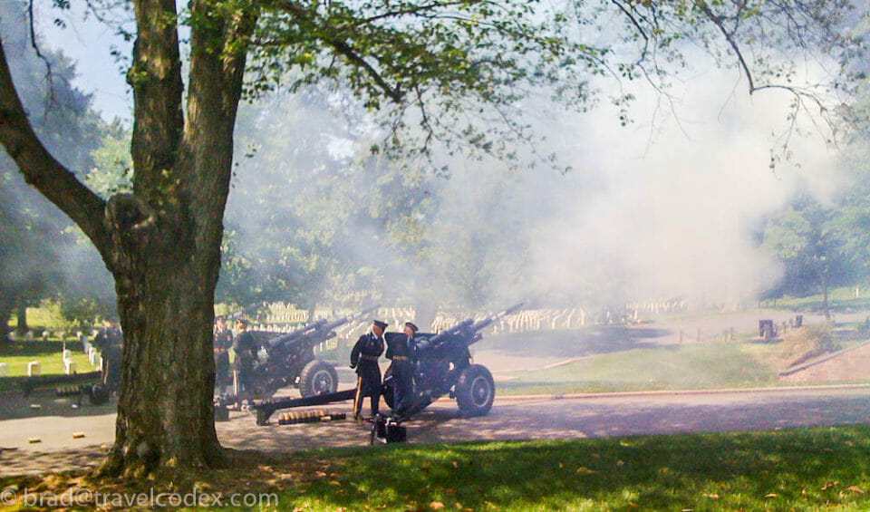 a group of men standing next to a cannon