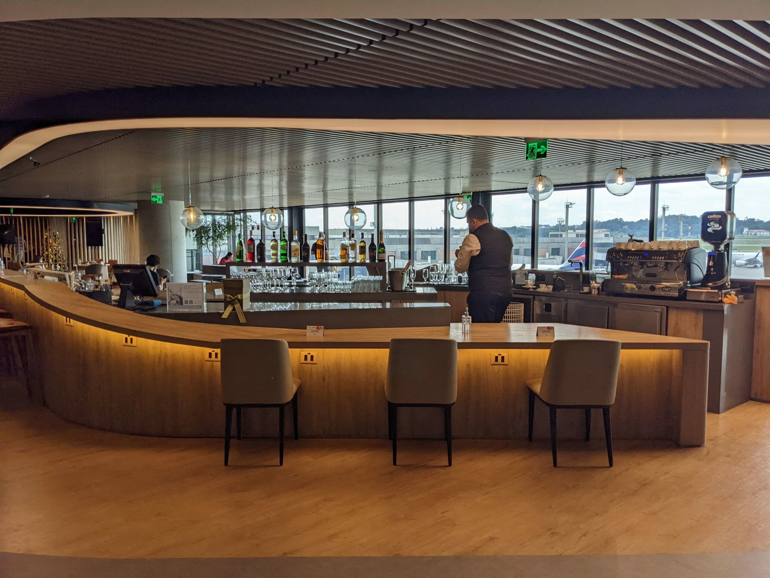 a man standing behind a bar