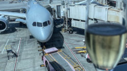 a glass of wine next to an airplane