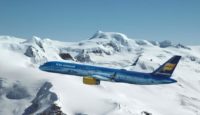 a plane flying over snowy mountains