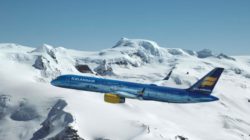 a plane flying over snowy mountains