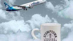 a white coffee mug with a plane flying in the air