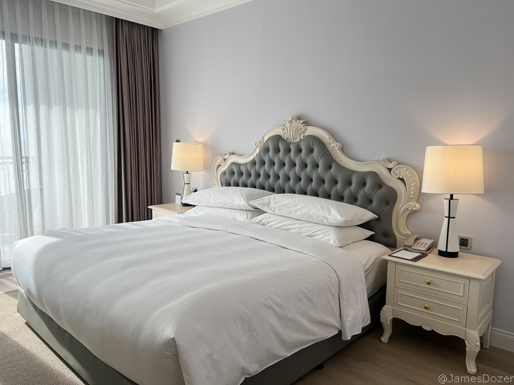 a bed with a white bed headboard and two lamps