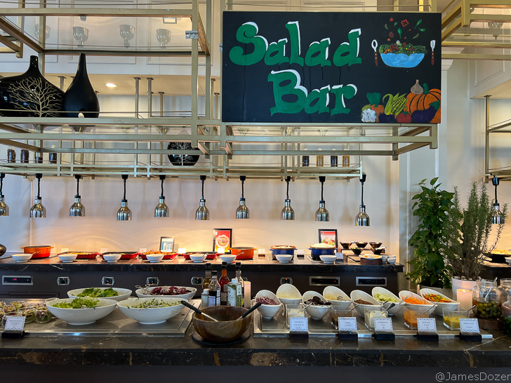 a salad bar with bowls of food
