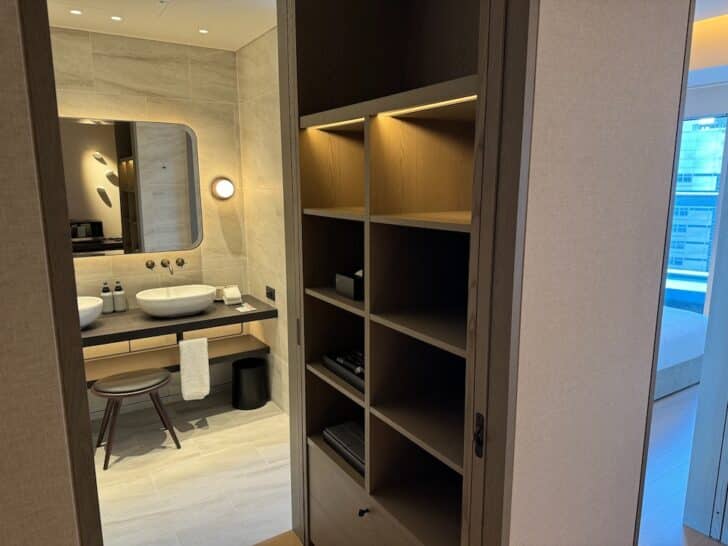 a bathroom with a mirror and shelves