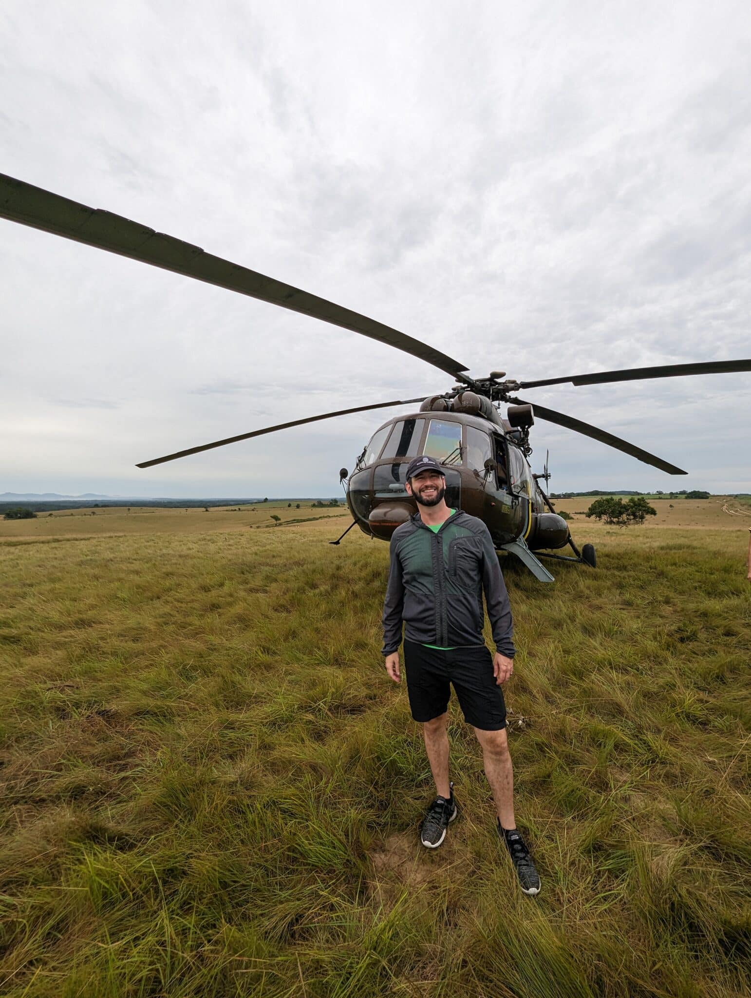 a man standing in front of a helicopter