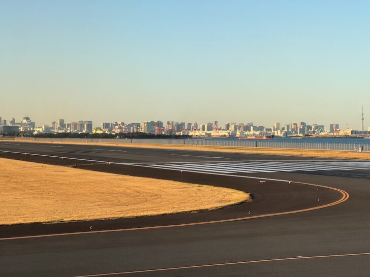 a runway with a city in the background