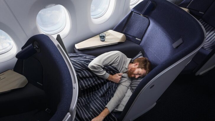 a man sleeping in a plane