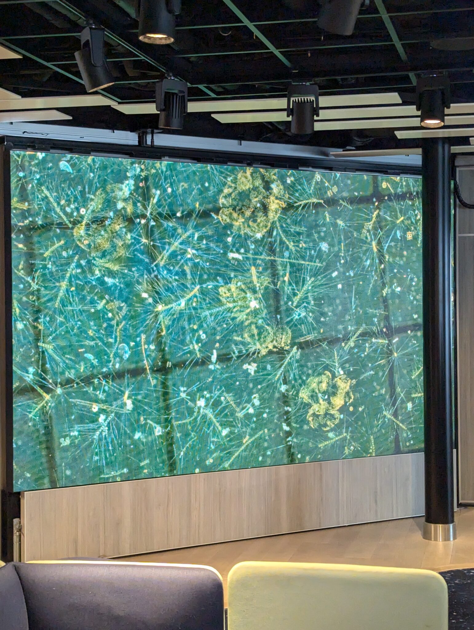 a large screen with a green and gold pattern