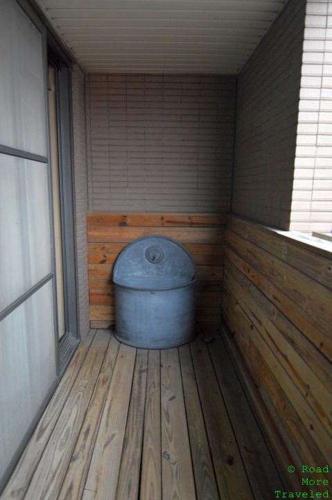 a metal bucket in a corner of a room