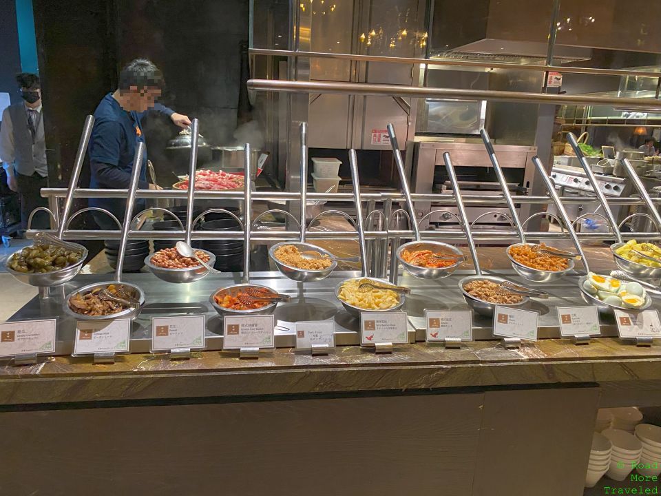 a large counter with bowls of food