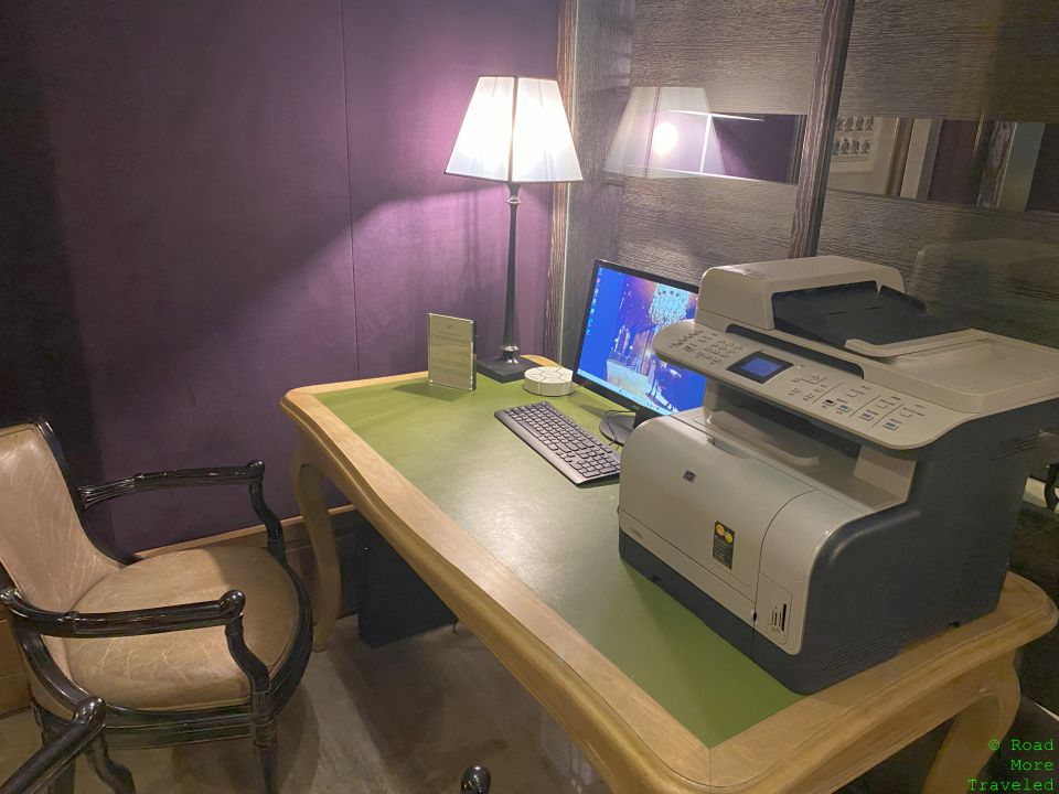 a desk with a printer and a computer