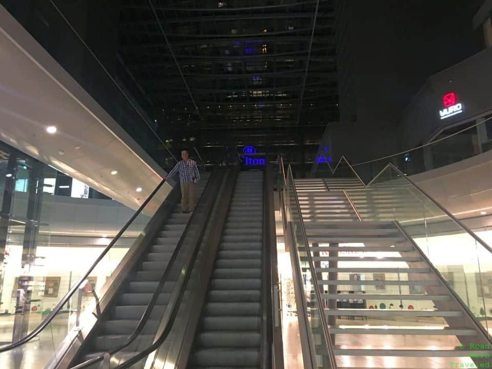 a man standing on an escalator