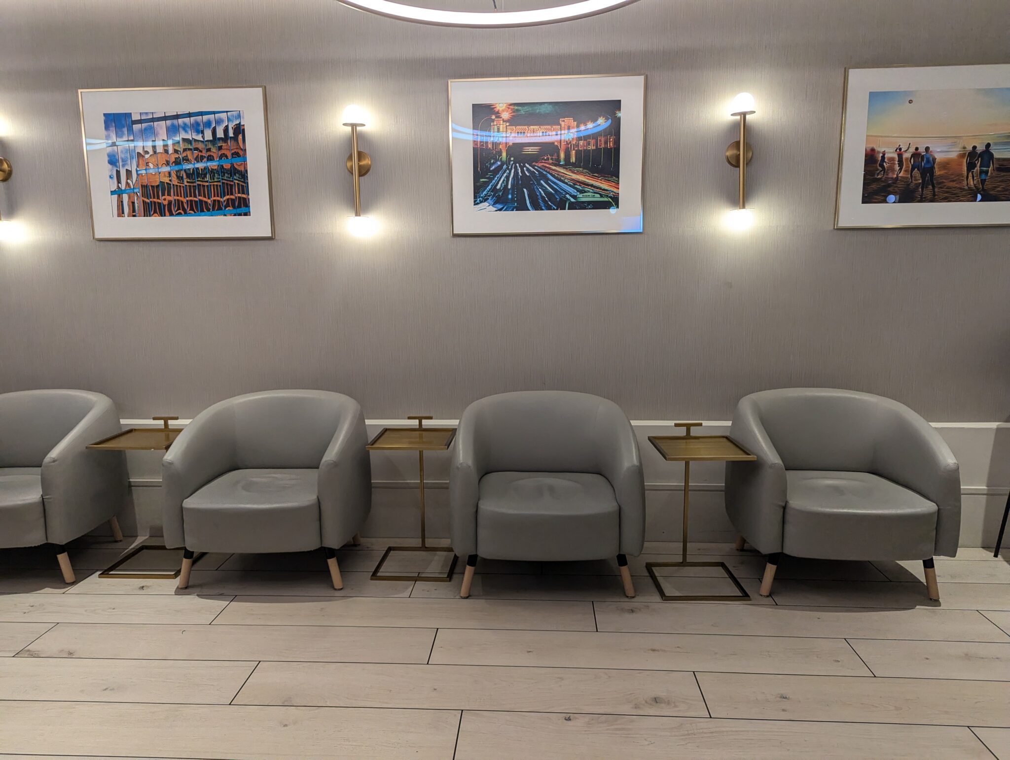 a group of chairs and a table with pictures on the wall