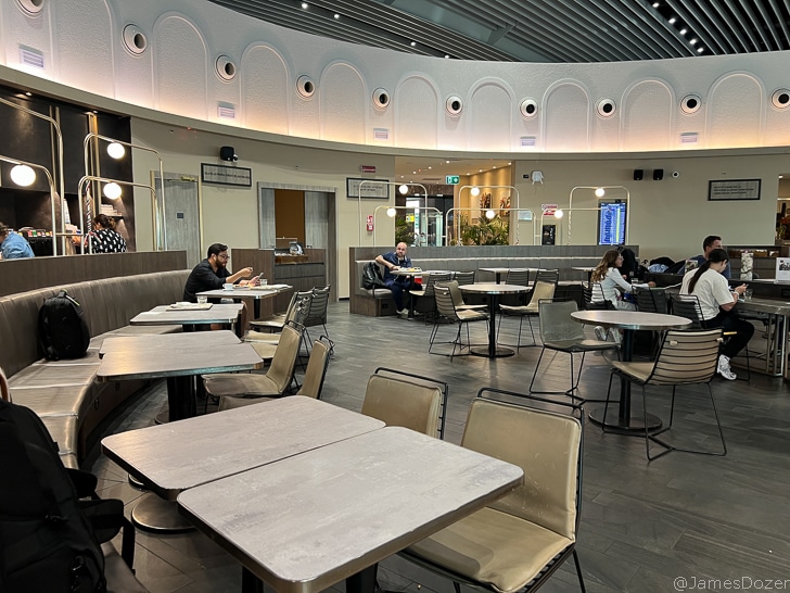 a group of people sitting at tables in a restaurant