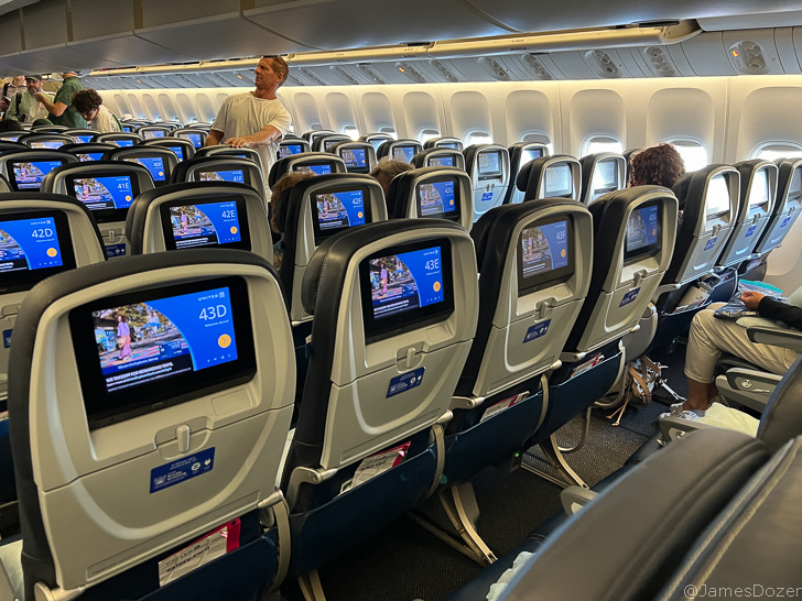 a row of seats with a man standing in front of them