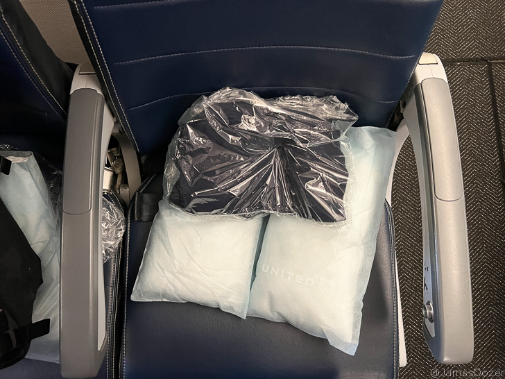 a seat with a bag of white and black objects on it