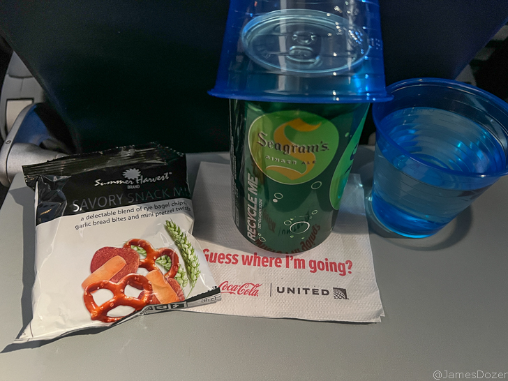 a snack pack and a drink on a napkin