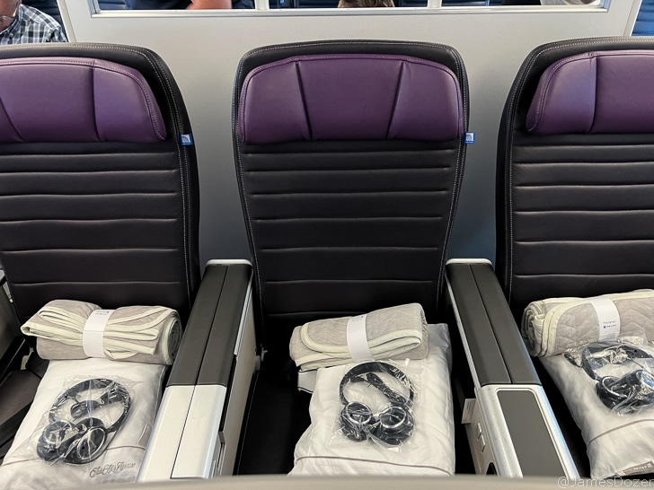 a row of seats with a few rolls of towels and a watch