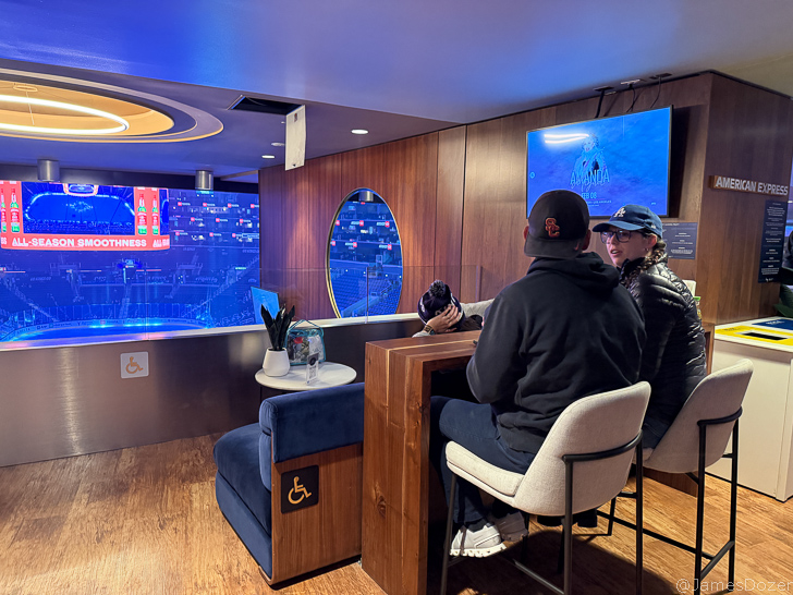 a couple of people sitting in a room with a television screen