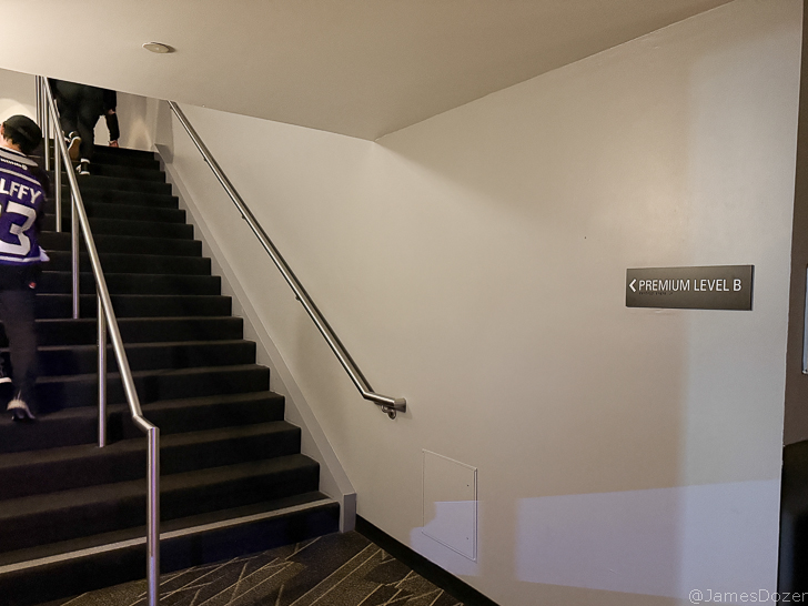 a staircase with a handrail and a sign