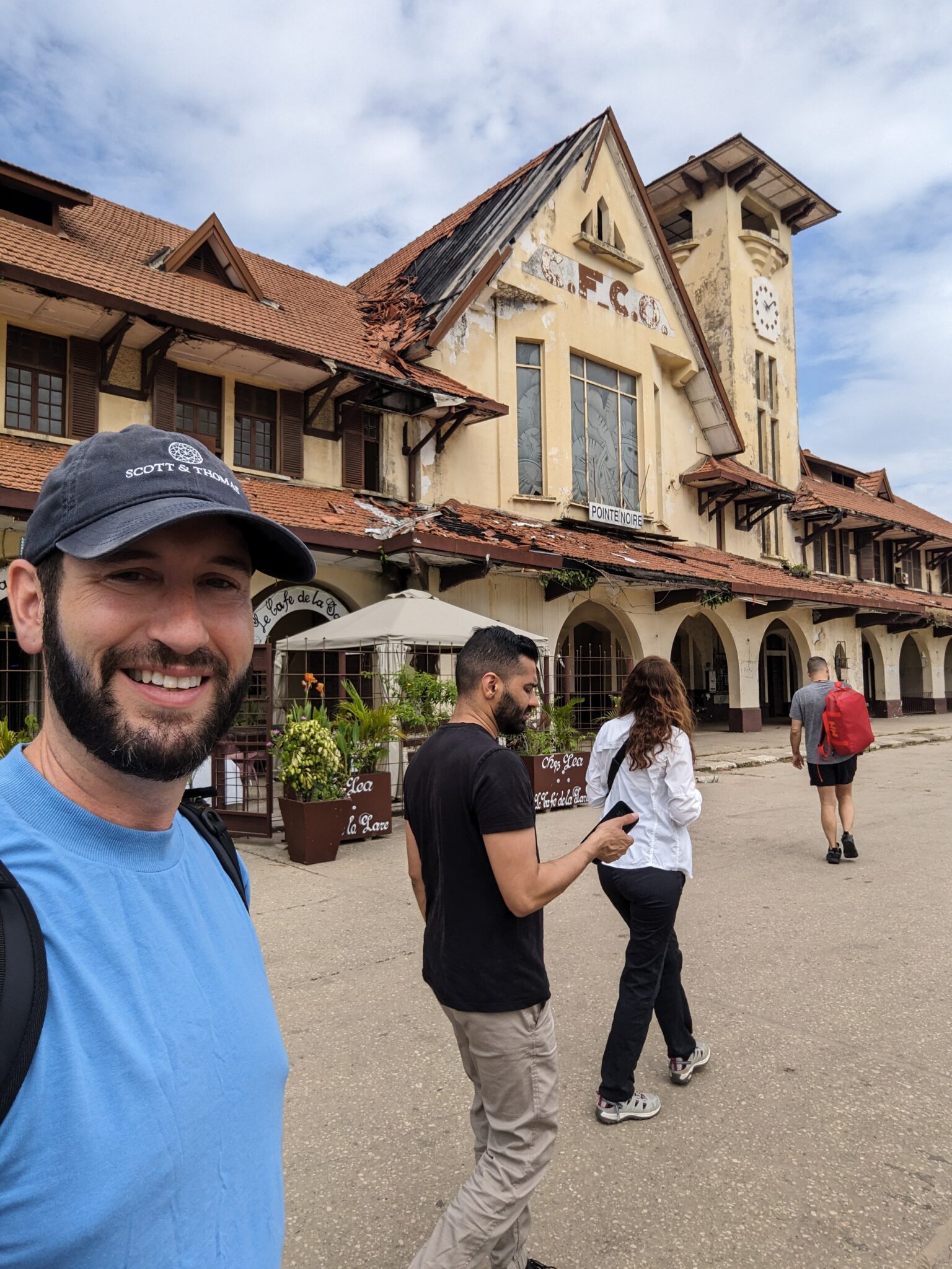 a man taking a selfie in front of a building