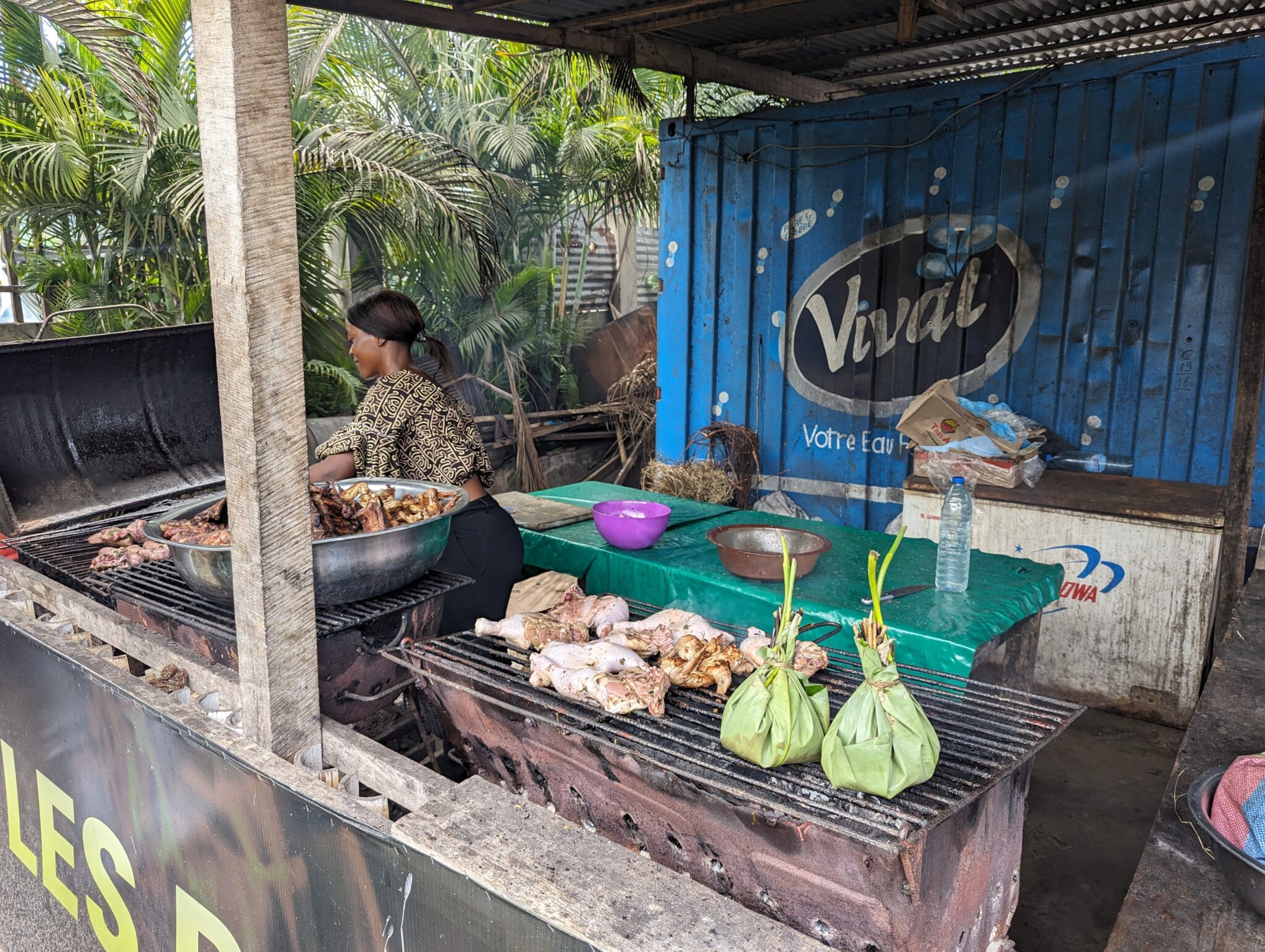 a woman cooking meat on a grill