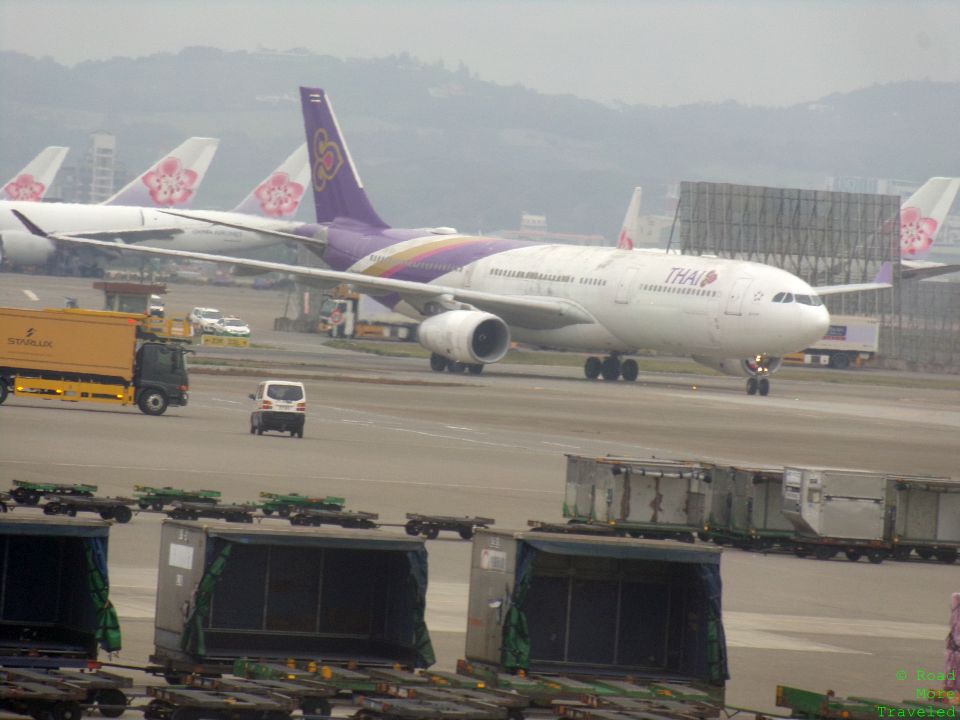 a large white and purple airplane on a runway