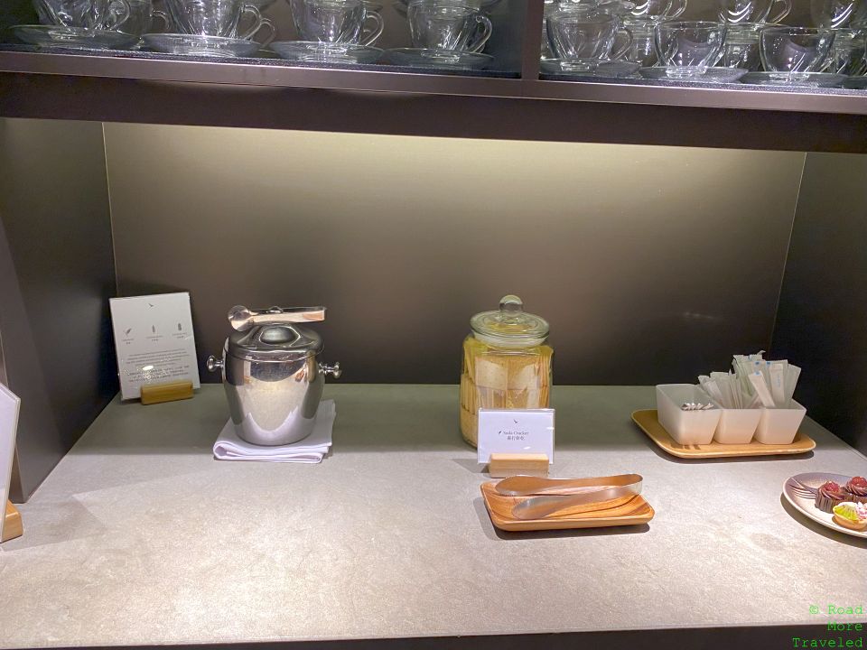 a table with utensils and a jar of sugar on it