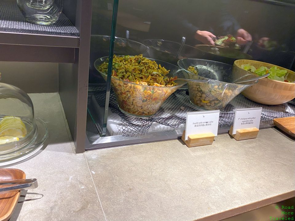 a glass display case with bowls of food