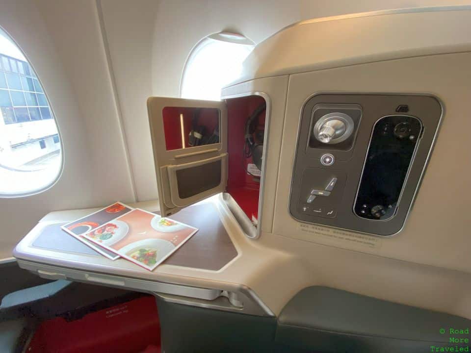 a table with a door open in an airplane