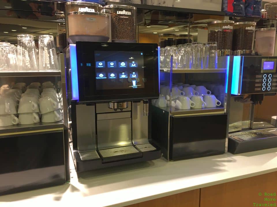 a coffee machine and cups on a counter