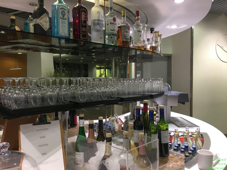 a shelf with bottles and glasses on it