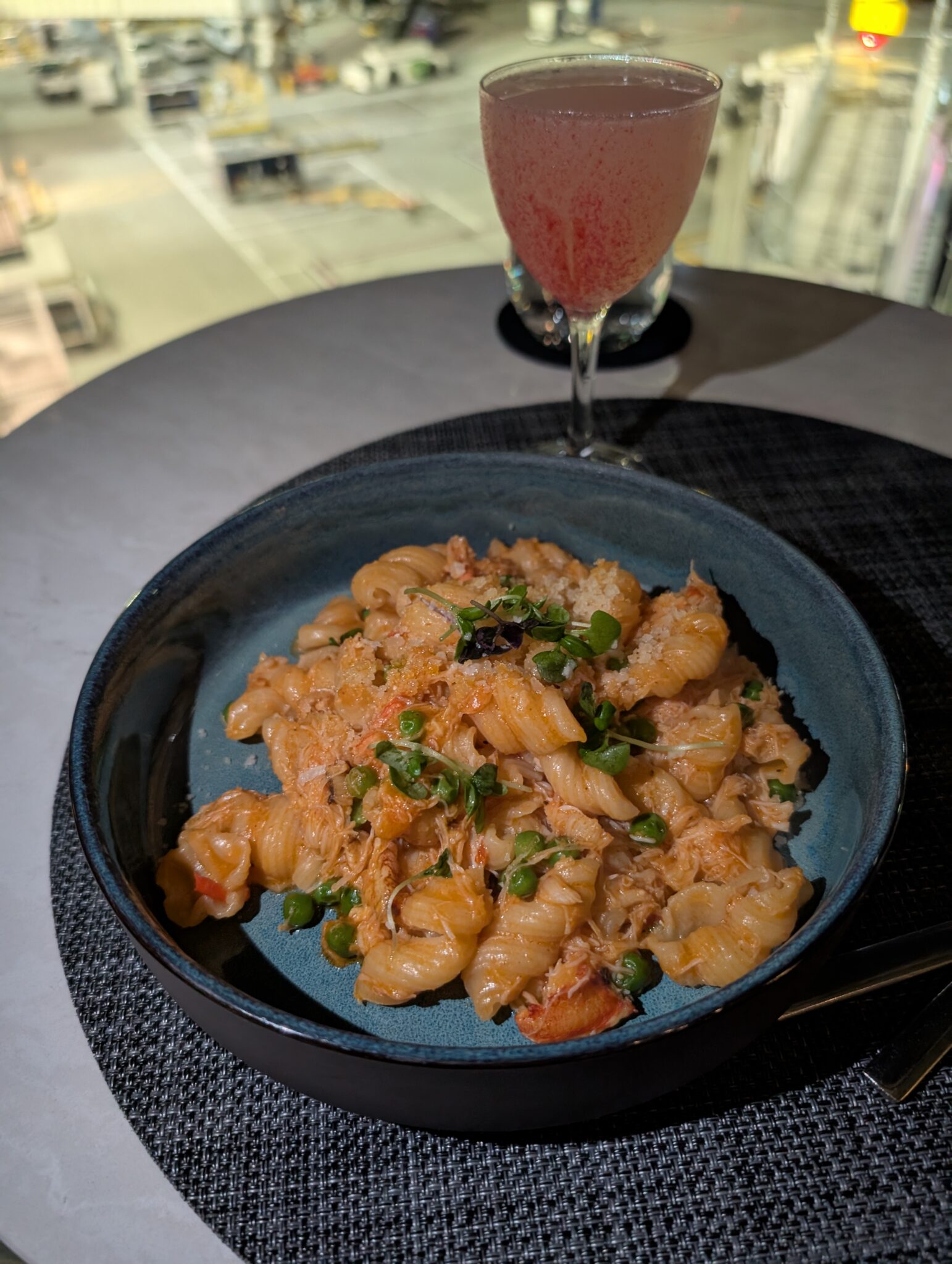 a bowl of pasta and a glass of liquid