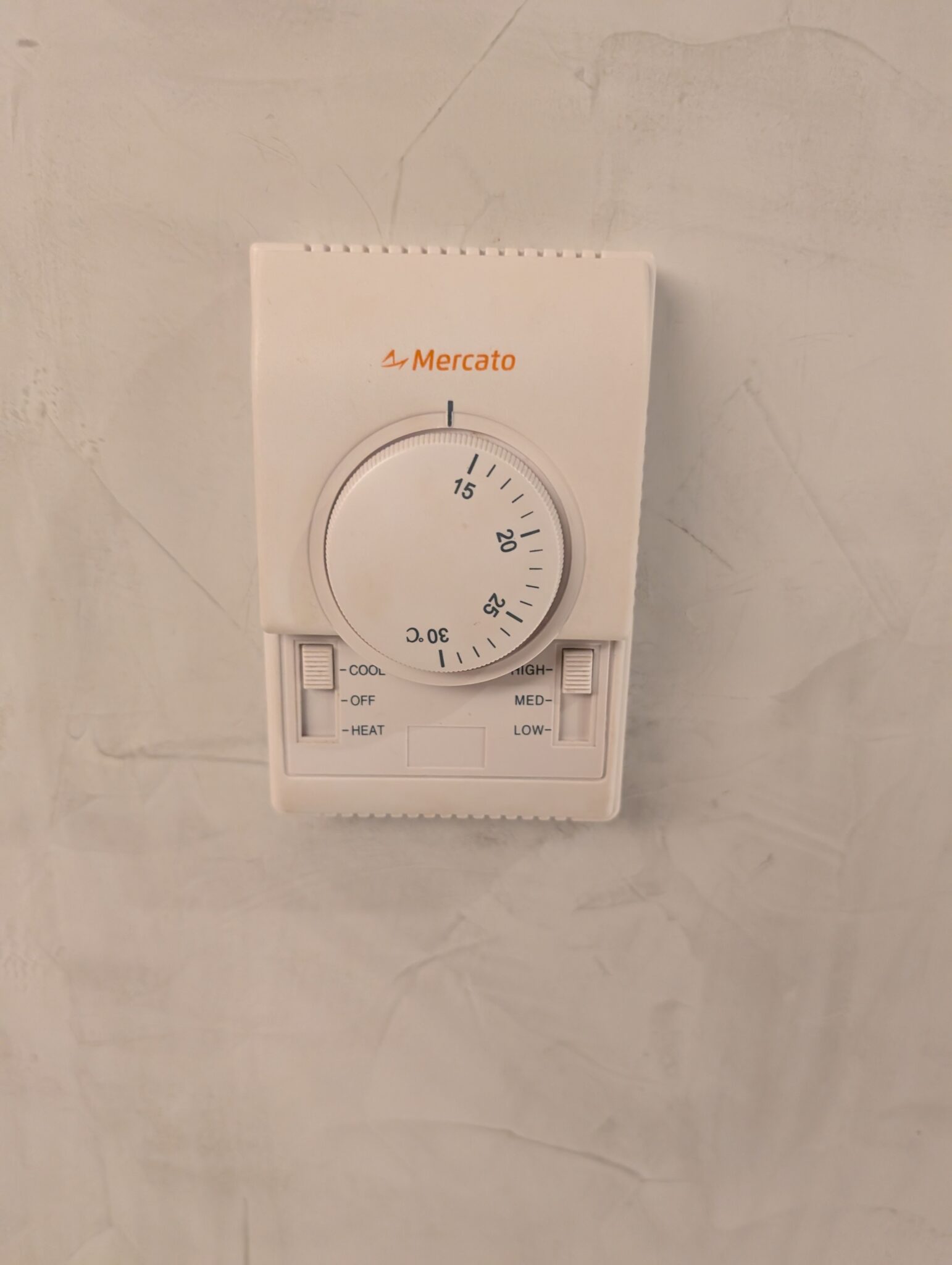 a white rectangular object with a dial