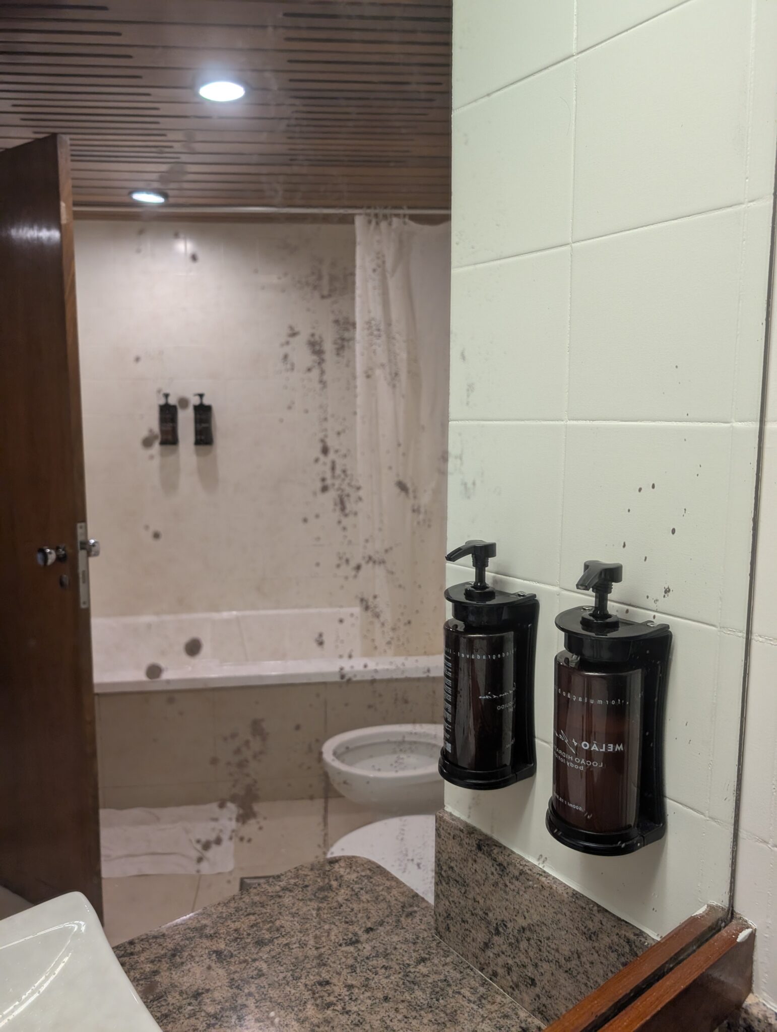 a bathroom with a sink and soap dispensers