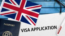 a flag and passport on a blue table